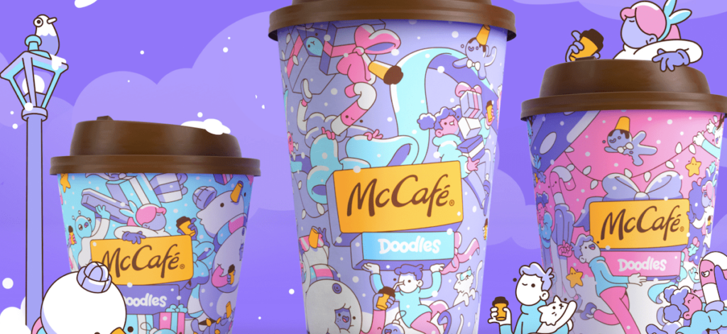 McDonald's coffee cups featuring Doodles NFT artwork with exclusive Web3 content and Pharrell Williams collaborations.
